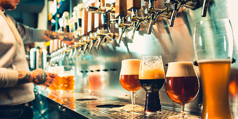 beers being poured at a bar