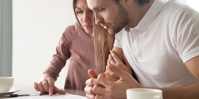 man and woman reviewing letter together