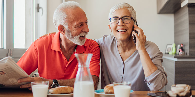 smiling older couple eating breakfast