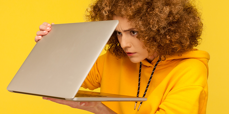 person looking suspiciously at their laptop
