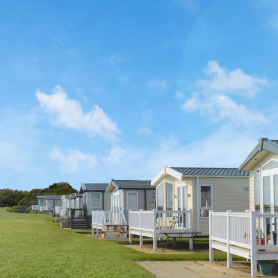 Row of houses with green grass on a sunny day