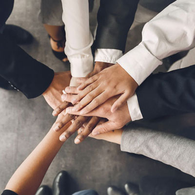 Top down view of hands joining together