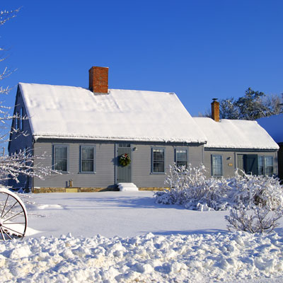 Blue house with snow on it