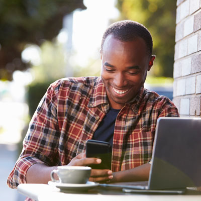 Man looking at phone and seeing STAR credit was direct deposited into bank account
